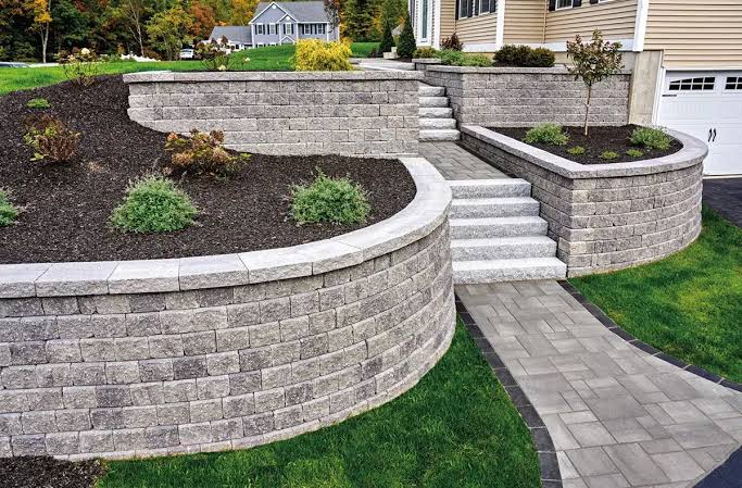 Stone retaining wall construction by ATL Land & Hardscaping